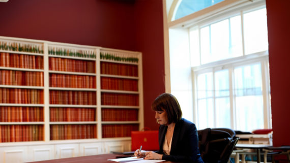 The Chancellor of the Exchequer, Rachel Reeves, sits in Number 11 Downing Street. In an office, she sits at a table working next to the red briefcase.